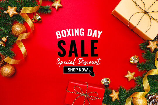 Boxing day sale with Christmas present and xmas decoration on red background
