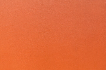 Plastered wall painted orange colour background.