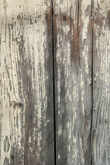 Old grunge weathered wooden boards with cracked paint closeup as wooden background