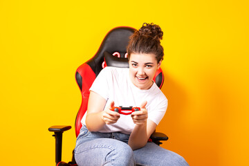Woman playing video games while sitting on a gaming chair, free time activity, new hobby woman...