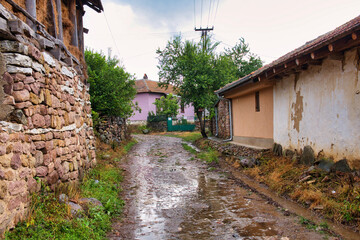 Fototapeta na wymiar Old traditional village in Stara Planina mountains on a rainy summer day 