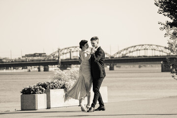 Young couple dancing tango against the old city background. Travel and lifestyle concepts. Black...