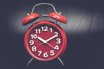 red clock  on black background, copy spaсe.