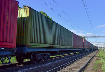 Obraz premium Cargo Containers Transportation On Freight Train By Railway. Intermodal Container On Train Car. Rail Freight Shipping Logistics Concept. Import - export goods from Сhina.