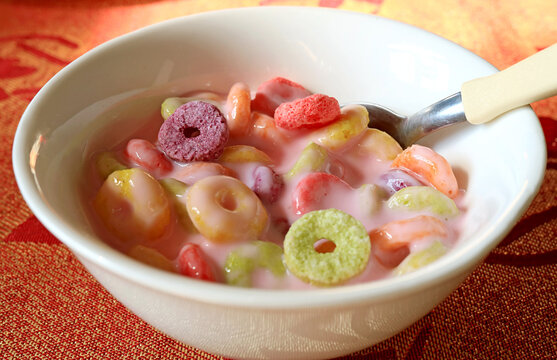 Bowl Of Sugary Ring Shaped Cereal Mixed With Strawberry Flavored Yogurt