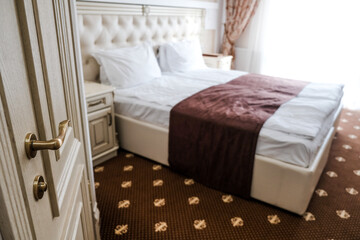 Luxury hotel room on a tourist retreat. Entering the suite, door open and bed in the background....
