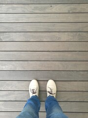 Woman standing on wooden board