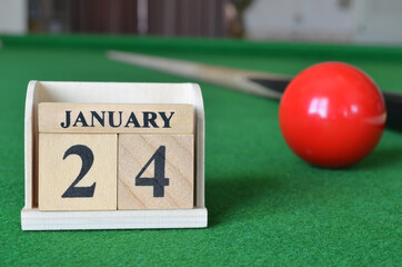 January 24, number cube with balls on snooker table, sport background.