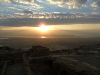 Fototapeta na wymiar Sunrise hike to the old ruins of the archeological site of Masada in Israel by the Dead Sea