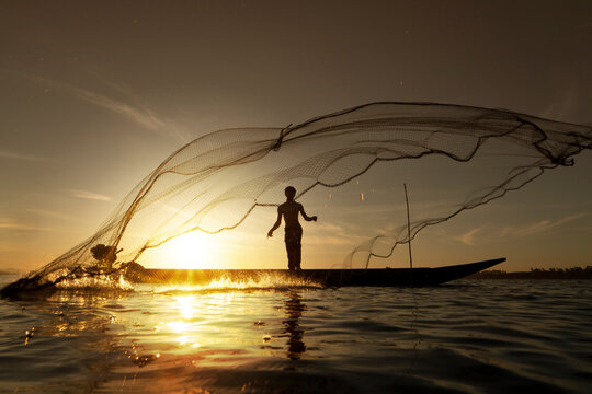 Man Throws Fishing Net Image & Photo (Free Trial)