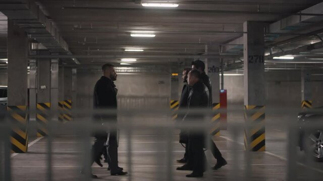 Tracking of two multi ethnic criminal gangs meeting for money transferring and talking at dark isolated underground parking