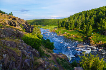 Many rapids with waterfalls, spray foam and whirlpools close-up, rotate camera. Ural region,...