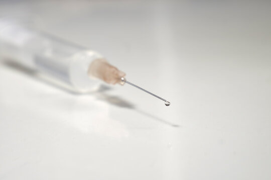 syringe with corona, COVID-19 vaccine, extreme close up, free copy space, symbol picture