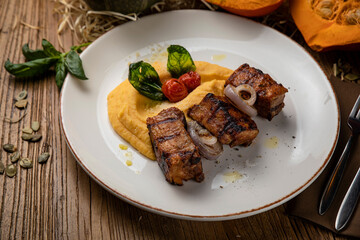 Roast pork with pumpkin puree, tomato, onion and basil
