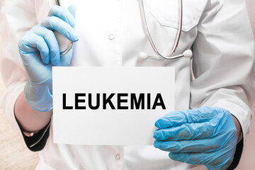 The doctor's blue - gloved hands show the word LEUKEMIA - . a gloved hand on a white background. Medical concept. the medicine