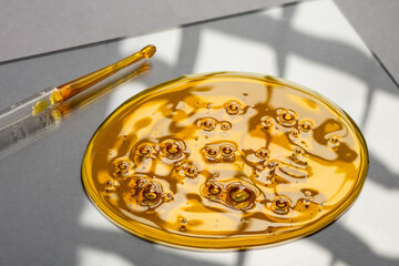 Yellow viscous liquid lecithin with bubbles on glass