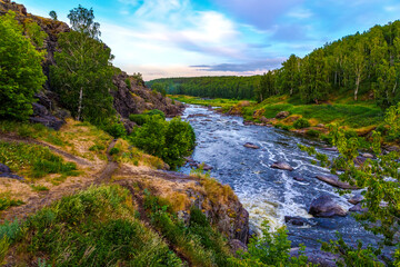 Fototapeta na wymiar Many rapids with waterfalls, spray foam and whirlpools close-up, rotate camera. Ural region, Russia. The threshold Revun.