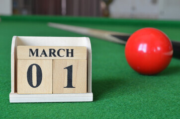 March 1, number cube with balls on snooker table, sport background.