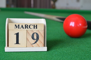 March 19, number cube with balls on snooker table, sport background.