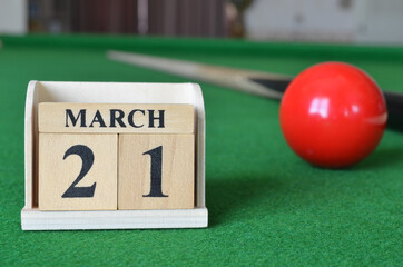 March 21, number cube with balls on snooker table, sport background.