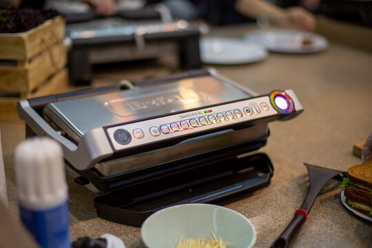 Moscow, Russia - October 04, 2019: professional electric grill Tefal Optigrill + XL Contact Grill with tray, model GC724D12 on the kitchen table, close up, soft focus