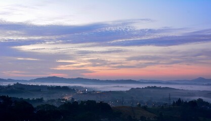 Beautiful Landscape of mountain layer in morning sun ray and winter fog
