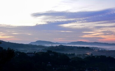 Beautiful Landscape of mountain layer in morning sun ray and winter fog