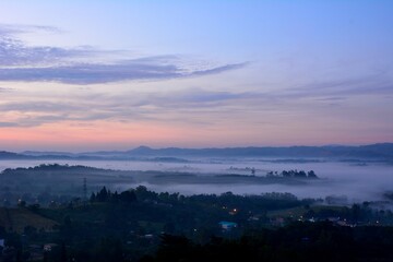 Fototapeta premium Beautiful Landscape of mountain layer in morning sun ray and winter fog