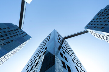 four connected business buildings pretty blue skyscrapers with square bridges windows blue sky upward view