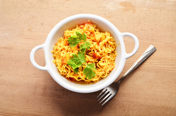 Maggi on white bowl wooden background