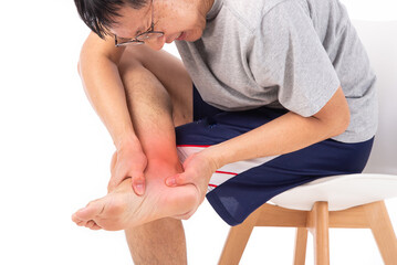 Sore pain of ankle. Sprain and arthritis symptoms. middle age man holding his hurt ankle