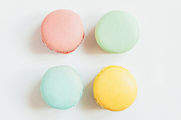 Sweet almond colorful pastel pink blue yellow green macaron or macaroon dessert cake isolated on white background. French sweet cookie. Minimal food bakery concept. Flat lay top view copy space