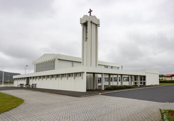 Fototapeta na wymiar Modern Grindavikurkirkja yngri church made of concrete in the centre of Grindavik city, Iceland