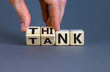 Think Tank concept. Blocks form the expression 'think tank'. Male hand. Beautiful grey background. Business concept. Copy space.