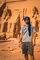 Portrait of a young tourist with a blue turban visiting the Abu Simbel Temple in southern Egypt in...