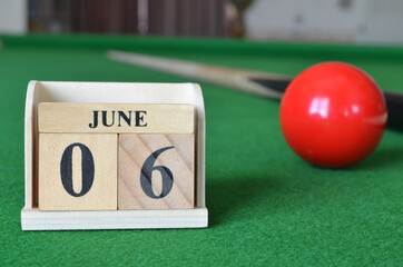 June 6, number cube with balls on snooker table, sport background.