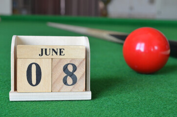 June 8, number cube with balls on snooker table, sport background.