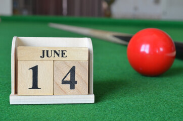 June 14, number cube with balls on snooker table, sport background.