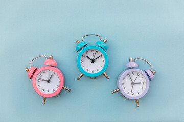 Simply minimal design three ringing twin bell classic alarm clock Isolated on blue pastel...