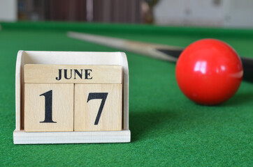 June 17, number cube with balls on snooker table, sport background.