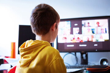 Child at home having remote school on laptop computer.