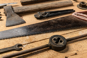 Variety of old vintage household hand tools still life on a wooden background in a DIY and repair concept