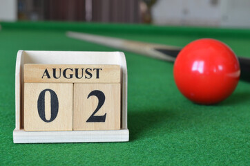 August 2, number cube with balls on snooker table, sport background.