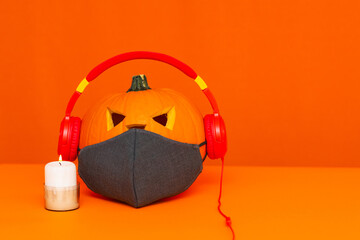 Happy Halloween decorations concept background.Mix variety candle items face mask and pumpkin listening music