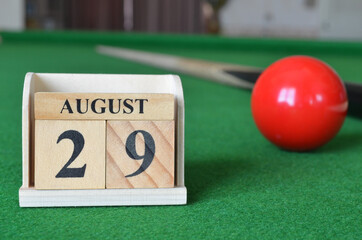 August 29, number cube with balls on snooker table, sport background.