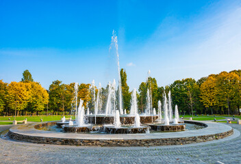 fountain in the park with colourful trees in autumn