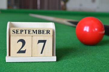 September 27, number cube with balls on snooker table, sport background.