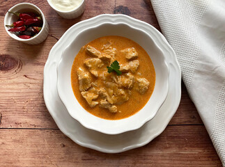 Traditional Hungarian chicken goulash, also known as chicken paprikash, or paprika chicken, in juicy paprika sour cream sauce and parsley.