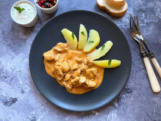 Traditional Hungarian chicken goulash, also known as chicken paprikash, or paprika chicken, in...