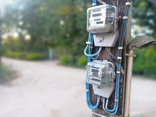 Chiangrai,Thailand, October 2020: 2 electric meters power with the pole next to street in a...